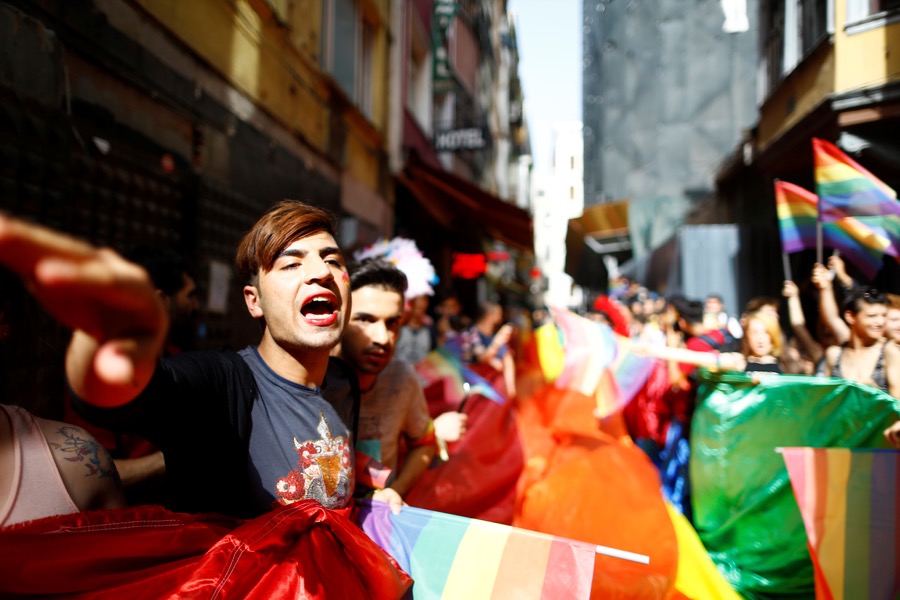 LGBT rights activists hold a rainbow flag during a transgender pride parade that was banned by the authorities in Istanbul on June 19. LGBT rights activists hold a rainbow flag during a transgender pride parade that was banned by the authorities in Istanbul on June 19.